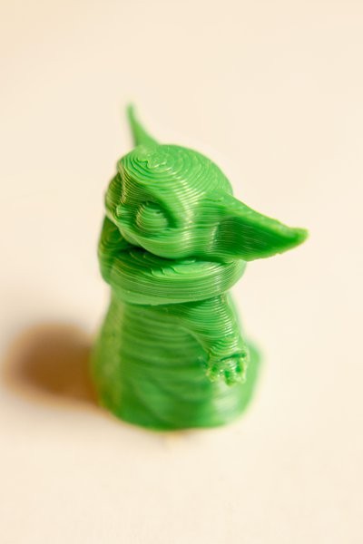 A 3D printed Yoda figurine with visible slices/layers