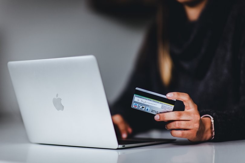 A person using a credit card for a purchase made online