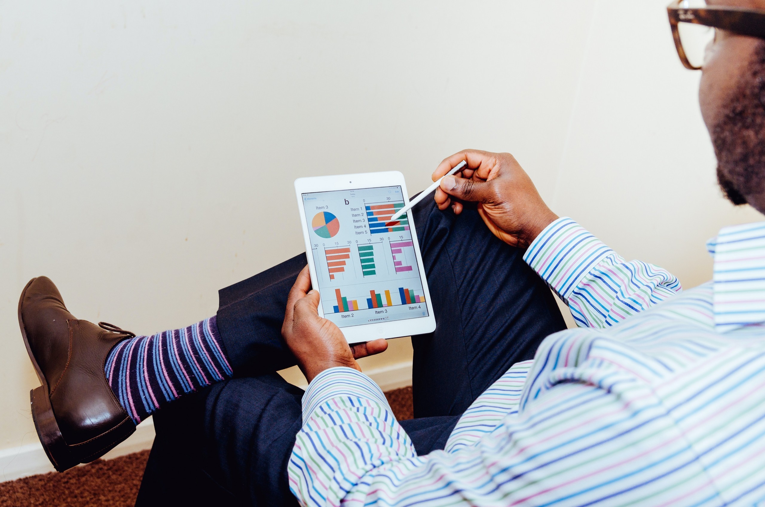 A person looking at data charts on a tablet