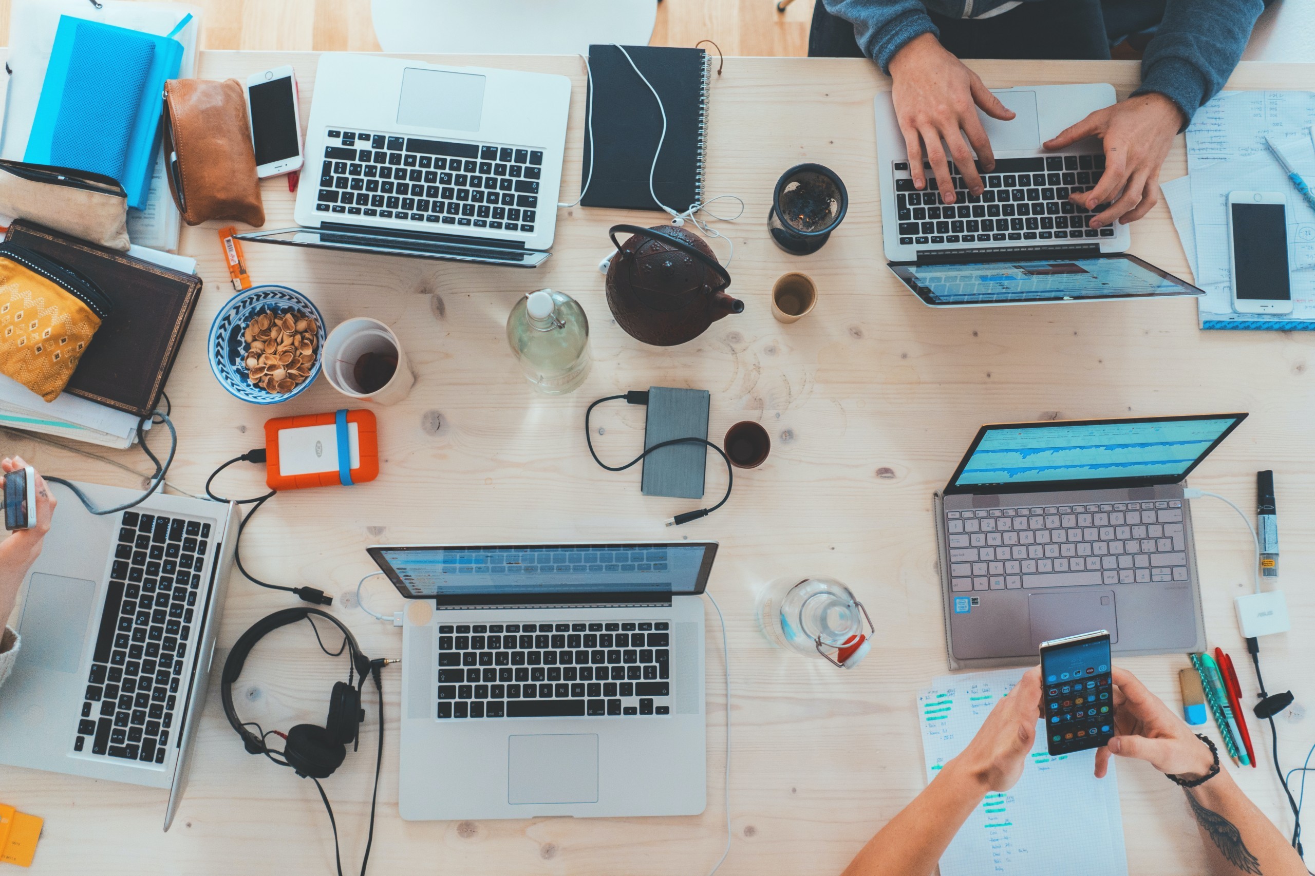 A work desk bearing laptops and other electronic devices